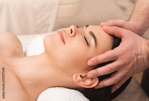 Head massage antistress. Relieve fatigue and relieve headaches using oriental massage. Woman at spa