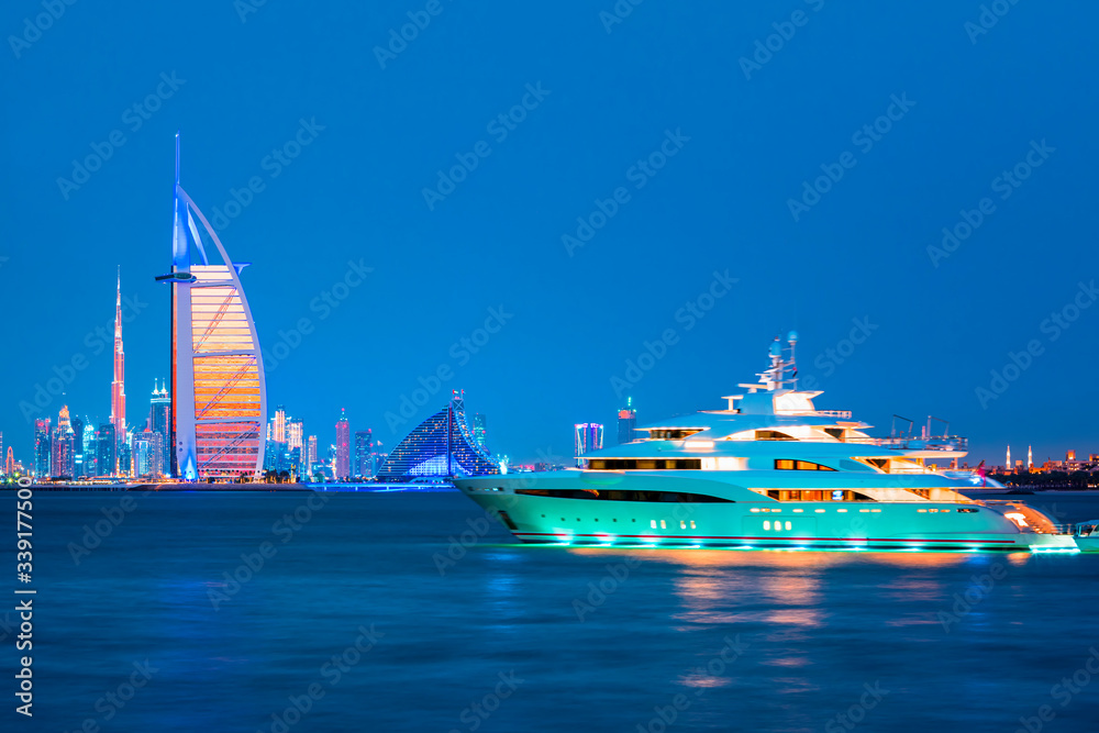 Fototapeta premium Dubai Marina, city of tourism from Palm Island at sunrise, United Arab Emirates
