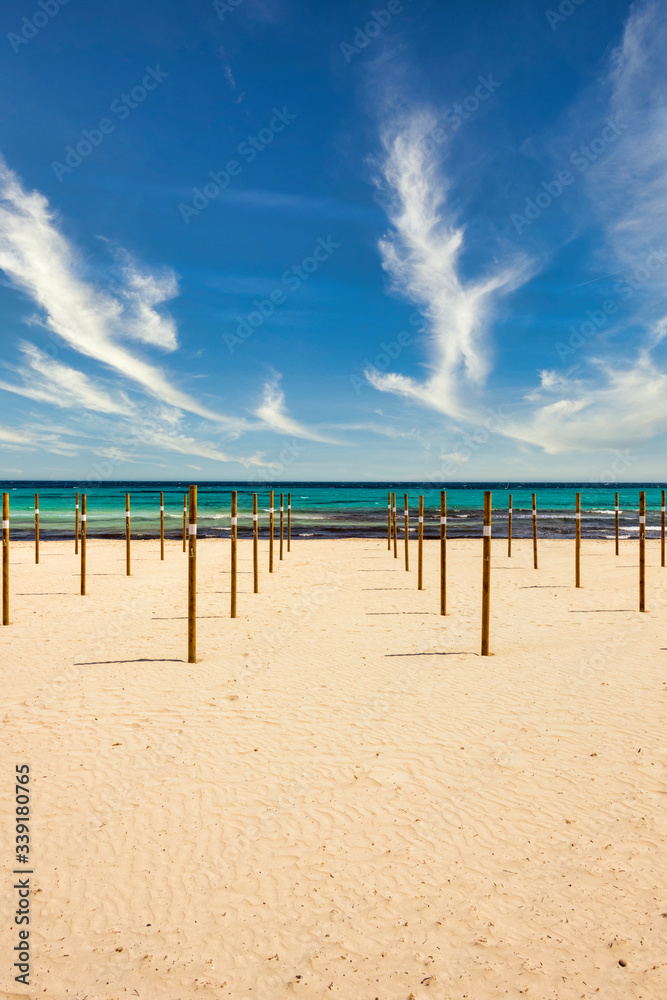 On Sa Coma on the Mediterranean island of Mallorca there are wooden poles in the beach on which the parasols are placed at the start of the season