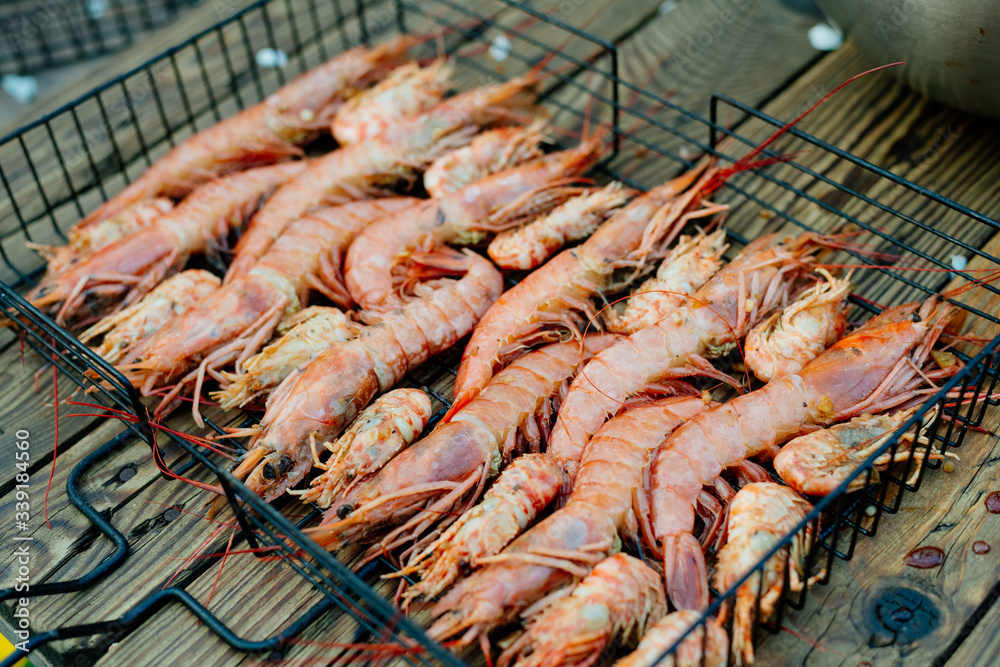 Grilled prawns. The process of cooking shrimp in soy sauce on the grill. Thai food.