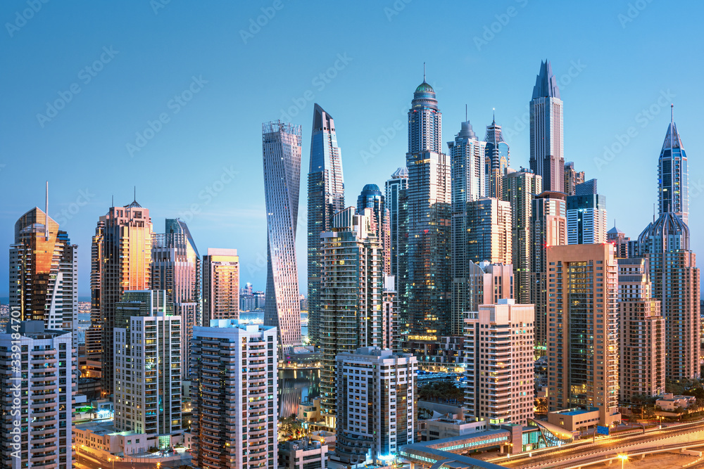 Obraz premium Amazing and Luxury Dubai Marina skyscrapers, famous Jumeirah beach skyscrapers at sunrise, United Arab Emirates