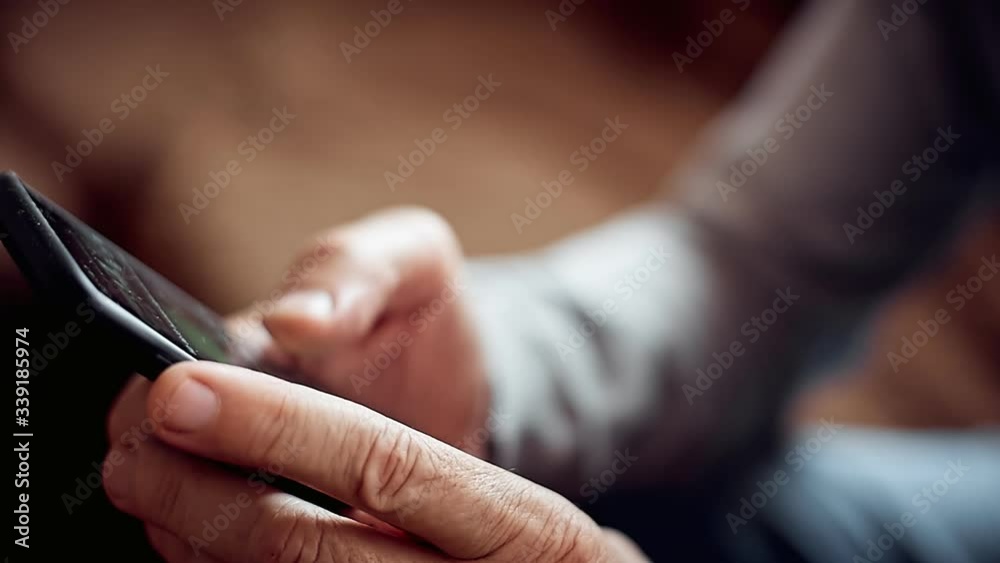 an elderly man with a smartphone in his hand, ordering goods from an online store with delivery during quarantine an elderly man with a smartphone in his hand, ordering goods from an online store with delivery during quarantine
