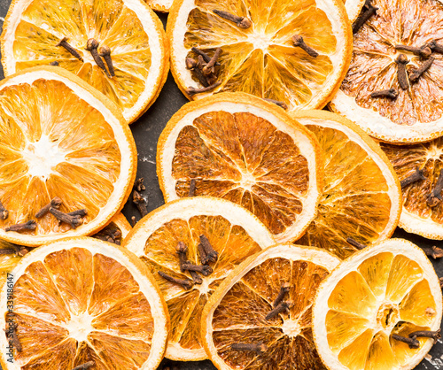 Dried orange slices with cloves on the rustic background. Selective focus. Shallow depth of field.