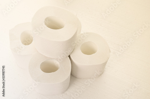 Hygiene and cleanliness. Rolls of toilet paper on a white background, toned