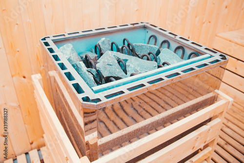 Closeup photo of oven with granite rocks at sauna.