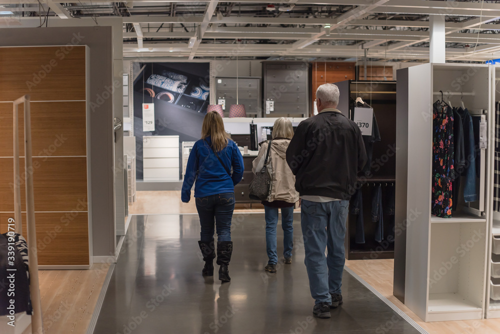 Fototapeta premium Back view Caucasian customers shopping at furniture and home furnishing store in Dallas, Texas, USA