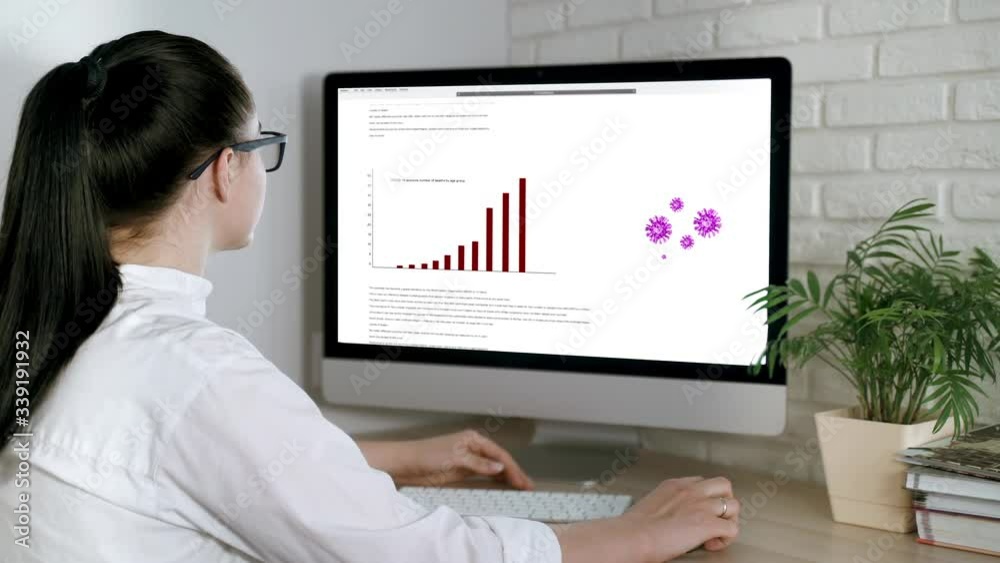 A woman reads news about the coronavirus epidemic on her computer