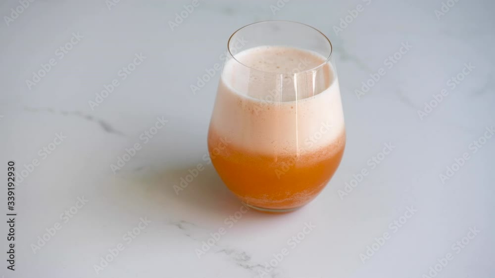 Orange Vitamin C effervescent tablet in water in a glass Orange Vitamin C effervescent tablet in water in a glass