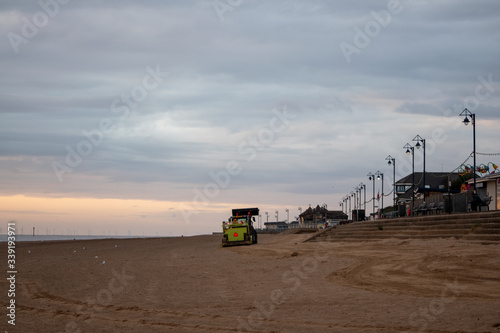 sunrise at the coast in mablethorpe uk. moody skies and blue sea photo