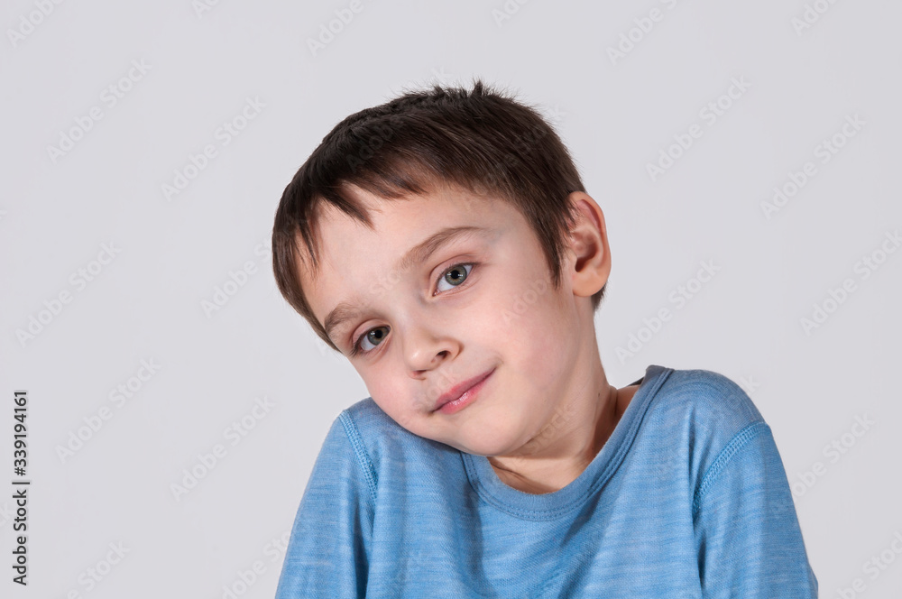 The boy confused shrugs his shoulders. He is confused (concept of human behavior) The boy confused shrugs his shoulders. He is confused (concept of human behavior)