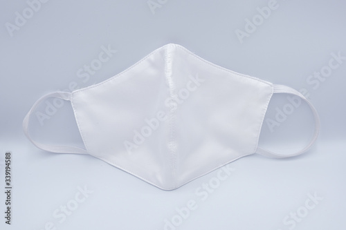 White cloth face mask for COVID-19 pandemic protection isolated on white background - Social distancing concept