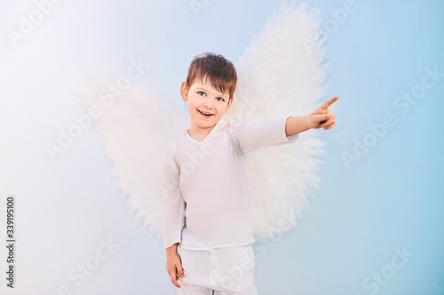 Angel boy in white with wings
