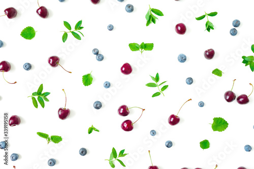 Fototapeta Naklejka Na Ścianę i Meble -  Cherry and blueberries with mint leaves on white background. Top view