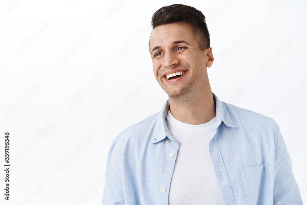 Happiness, family and emotions concept. Close-up portrait of handsome happy young man with stylish haircut, look away left empty space with pleased cheerful smile, laughing and rejoicing Happiness, family and emotions concept. Close-up portrait of handsome happy young man with stylish haircut, look away left empty space with pleased cheerful smile, laughing and rejoicing