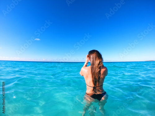 Girl bathing in azure water