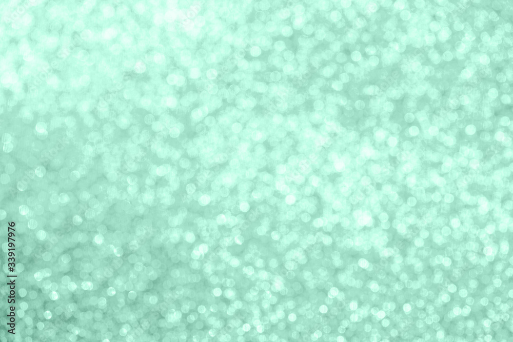 Christmas festive abstract background toned in neon mint color, soft focus.