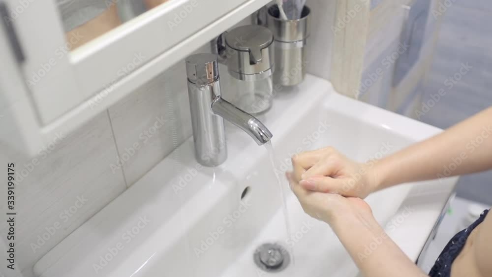 A girl washes her hands during an epidemic A girl washes her hands during an epidemic