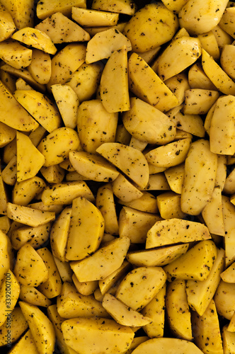 raw potatoes chopped into small pieces,baked potato,chopped potato background,yellow potato texture,seasoned potatoes,cooking baked potatoes