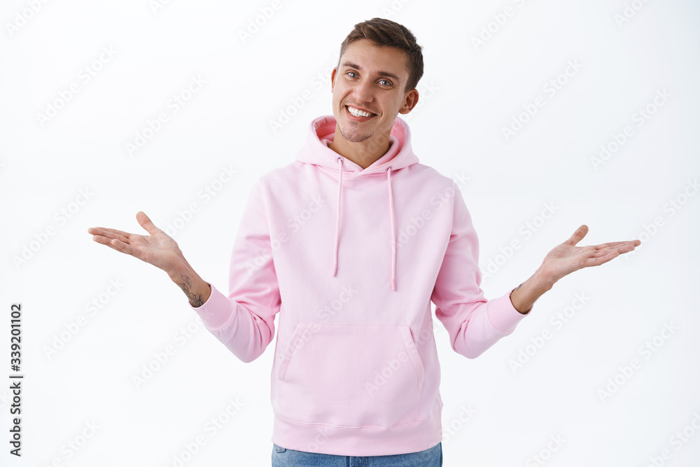 What can I say, no big deal. Portrait of confident happy blond caucasian guy, spread hands sideways and smiling upbeat, receive praises, professional in his work, stand white background What can I say, no big deal. Portrait of confident happy blond caucasian guy, spread hands sideways and smiling upbeat, receive praises, professional in his work, stand white background