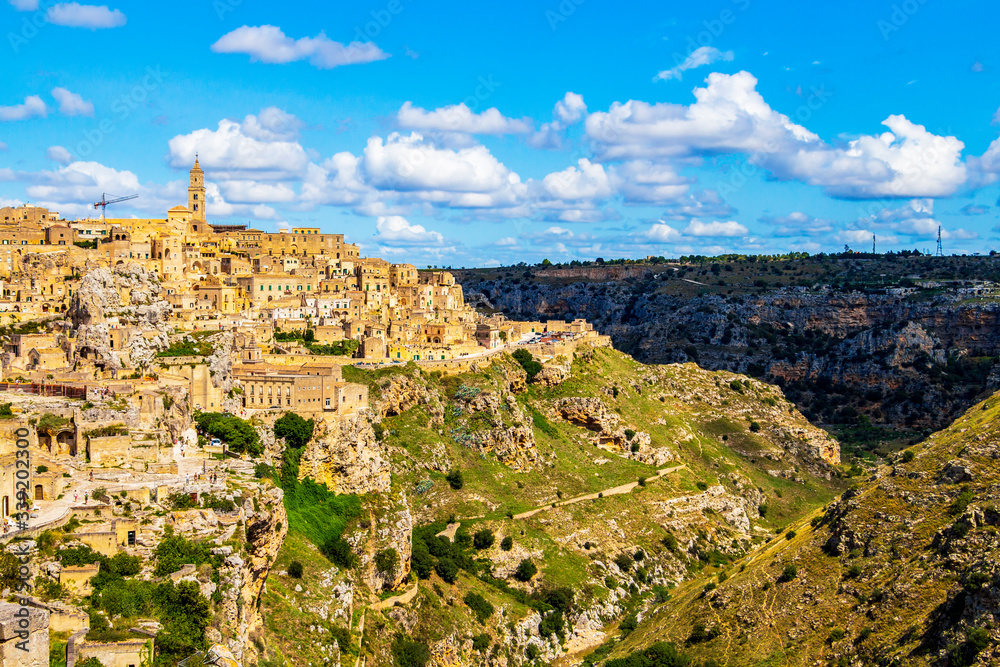 Fototapeta premium Scenic panoramic sunny summer view of Matera and the canyon of Matera in the Province of Matera, Basilicata Region, Italy