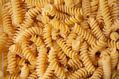 Fusilli pasta background macro view