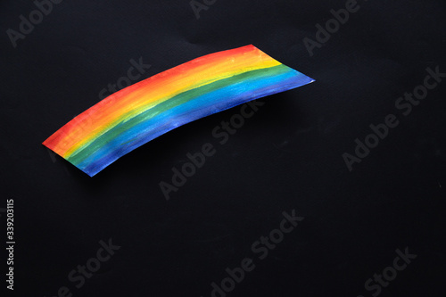 Rainbow cut and drawn on paper on a black background. CHASETHERAINBOW photo