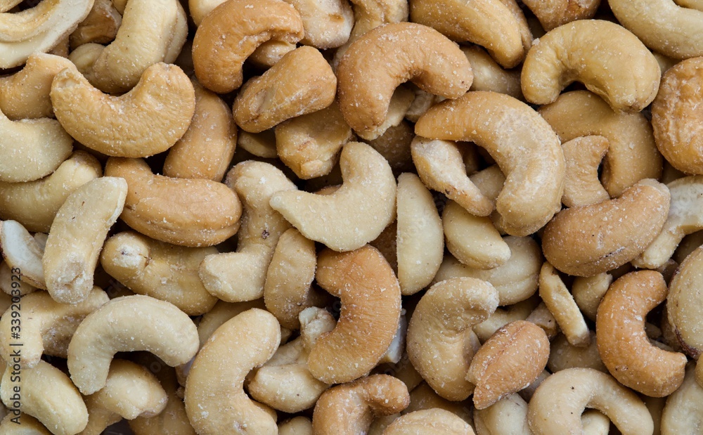 Cashew nuts, roasted and lightly salted. Macro image, full frame. Native to Brazil they are common as a snack and often used in Asian cuisine. They are high in carbohydrates, fats and vitamins. Cashew nuts, roasted and lightly salted. Macro image, full frame. Native to Brazil they are common as a snack and often used in Asian cuisine. They are high in carbohydrates, fats and vitamins.