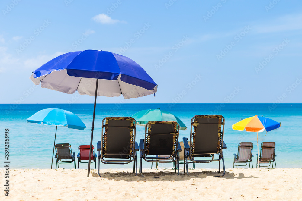 Beach in South of Thailand with no tourist, beach chairs with colorful umbrella on the paradise island, summer outdoor day light, holiday and vacation destination in Asia