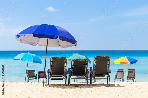 Beach in South of Thailand with no tourist, beach chairs with colorful umbrella on the paradise island, summer outdoor day light, holiday and vacation destination in Asia