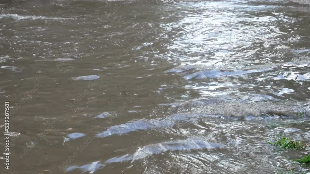 Deep wavy water after heavy downpour, deep and large dirty gray puddle was formed at the site of motorway Deep wavy water after heavy downpour, deep and large dirty gray puddle was formed at the site of motorway