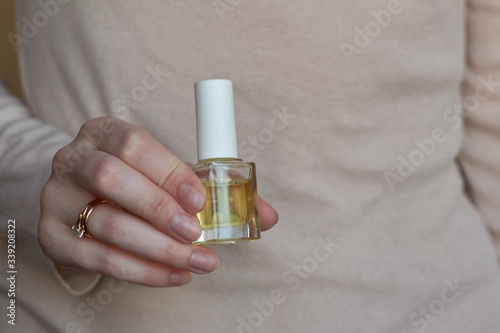 Woman giving herself elegant manicure applying polish on nails at home. Beauty treatment and hand care. Manicure at home. Quarantine.