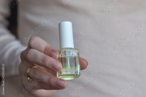 Woman giving herself elegant manicure applying polish on nails at home. Beauty treatment and hand care. Manicure at home. Quarantine.