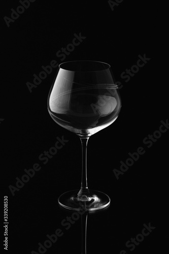 Clear empty wine glass isolated on black