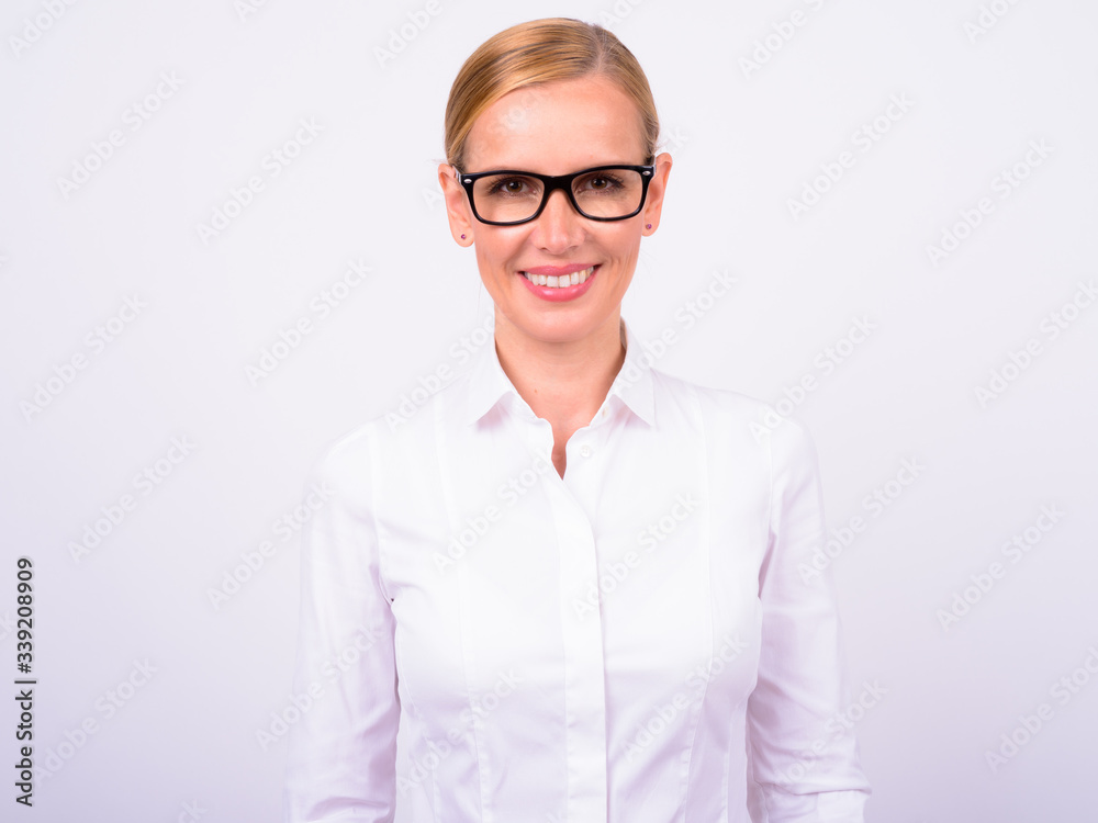 Portrait of happy beautiful blonde businesswoman with eyeglasses smiling