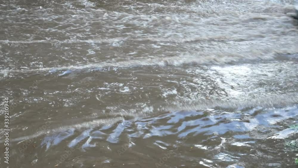 Deep wavy water after heavy downpour, deep and large dirty gray puddle was formed at the site of motorway Deep wavy water after heavy downpour, deep and large dirty gray puddle was formed at the site of motorway