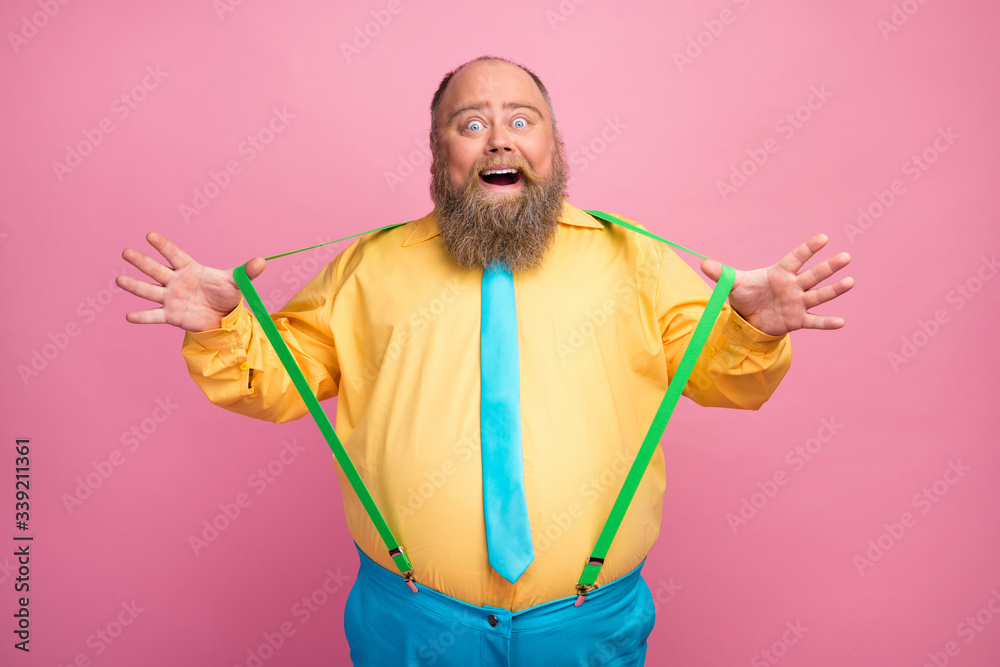 Portrait of his he nice funky carefree amazed bearded positive glad guy pulling suspenders having fun good mood isolated over pink pastel color background Portrait of his he nice funky carefree amazed bearded positive glad guy pulling suspenders having fun good mood isolated over pink pastel color background