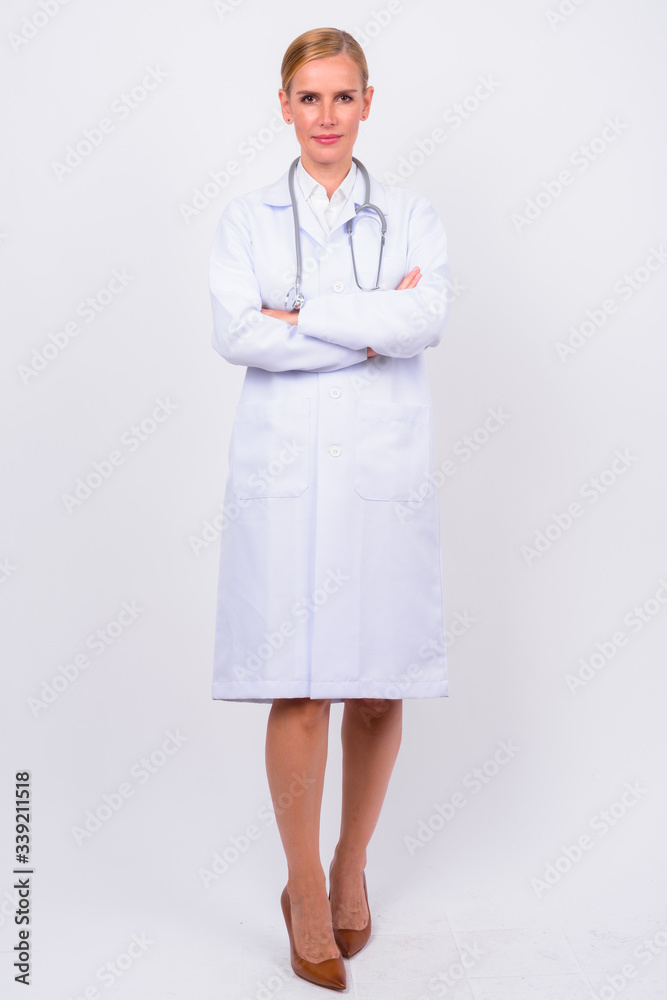 Full body shot of blonde woman doctor with arms crossed Full body shot of blonde woman doctor with arms crossed