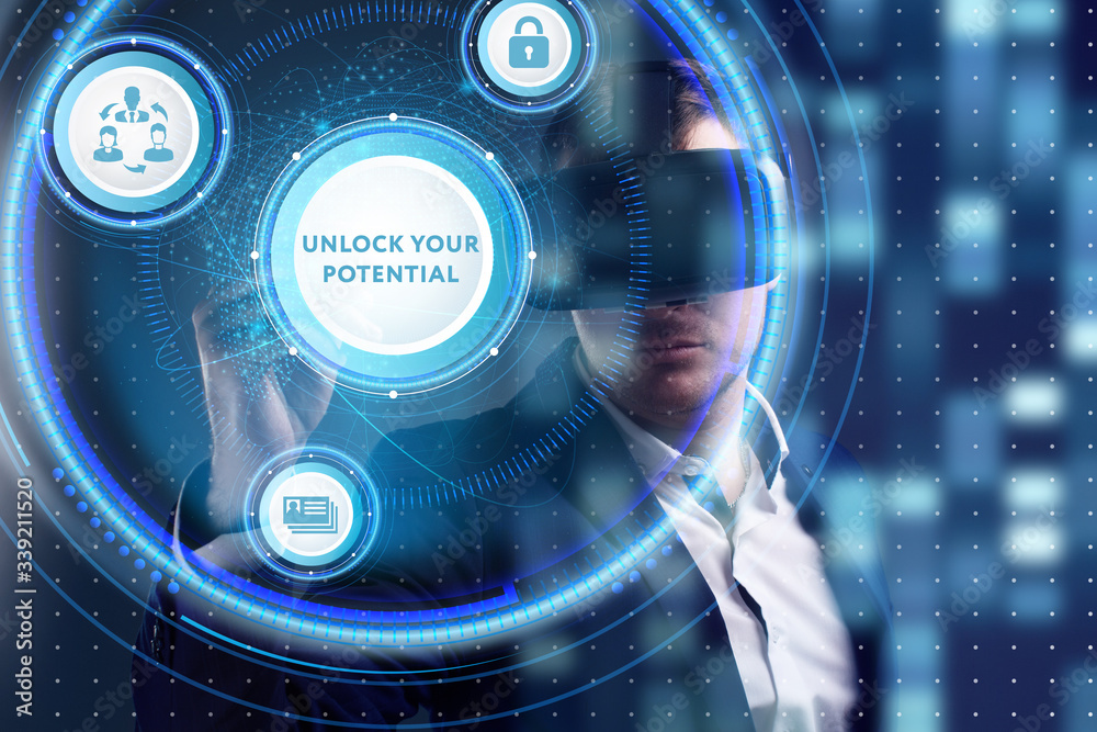 Business, Technology, Internet and network concept. Young businessman working on a virtual screen of the future and sees the inscription: Unlock your potential Business, Technology, Internet and network concept. Young businessman working on a virtual screen of the future and sees the inscription: Unlock your potential