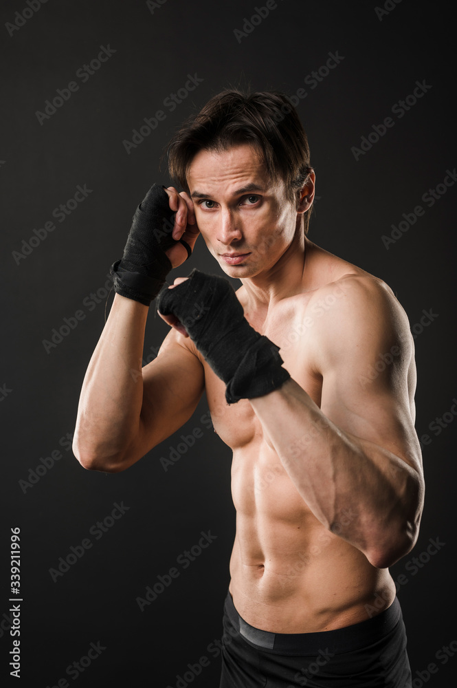 Shirtless athlete posing in boxing gloves