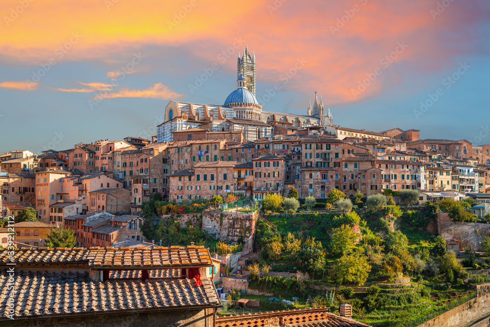 Siena - historical medieval town at sunset with view of the Dome & Bell Tower of Siena Cathedral (Duomo di Siena), landmark Mangia Tower and Basilica of San Domenico,Italy