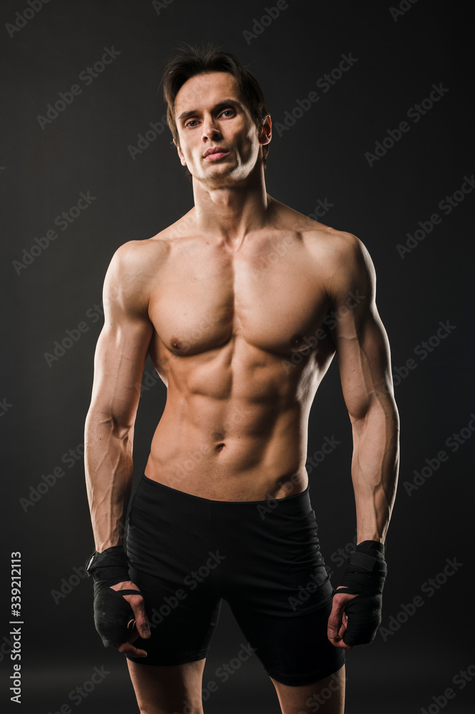 Shirtless muscle man. Athlete posing.