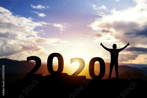 Silhouette freedom businessman happy with New year 2020