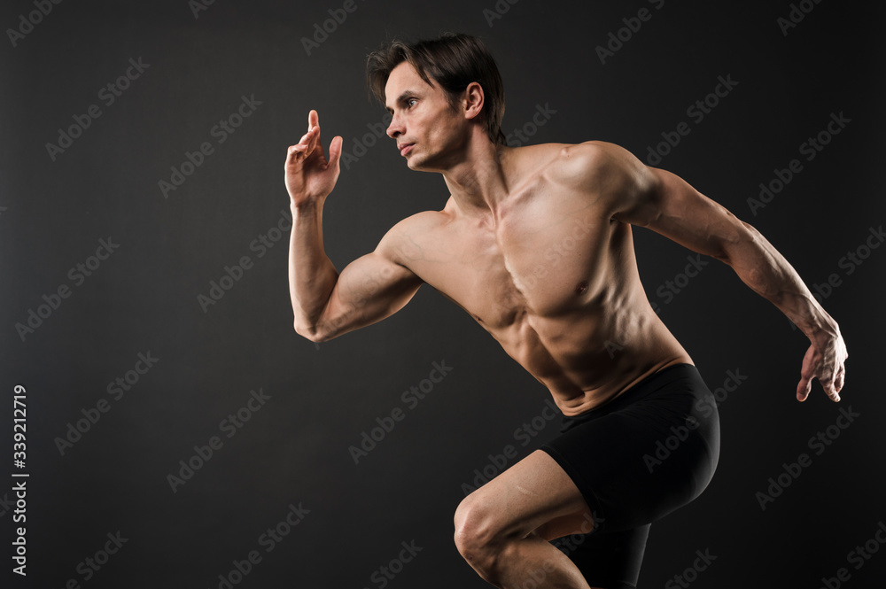 Side view of shirtless muscular man posing