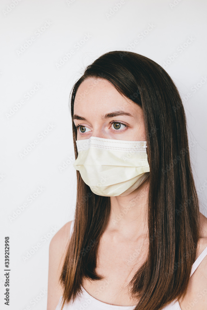 A girl in yellow protective mask. Close-up portrait. Pandemic coronavirus 2020. Quarantine. Virus concept. Epidemic infection.