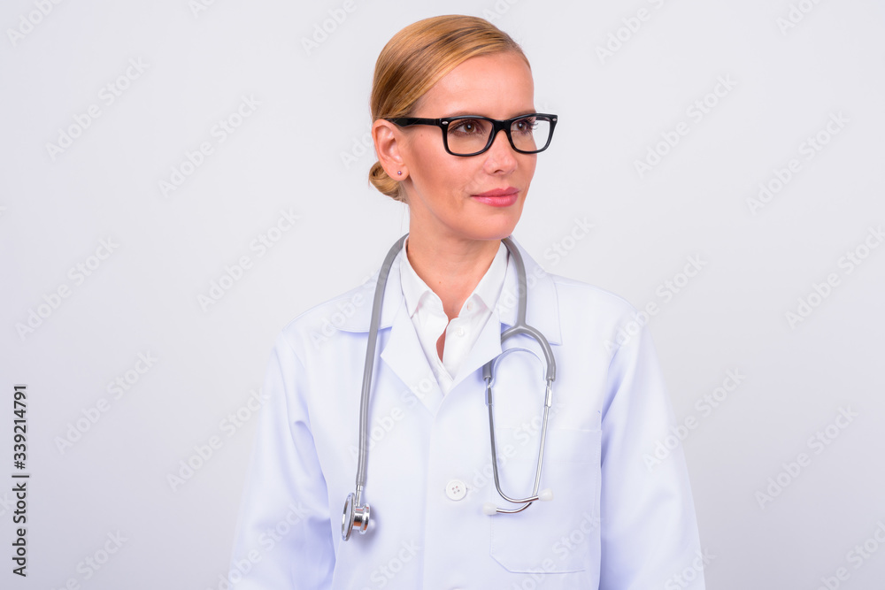 Portrait of blonde woman doctor with eyeglasses thinking