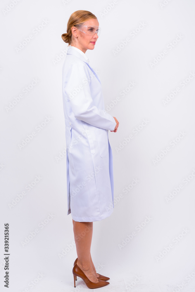 Full body shot profile view of blonde woman doctor as scientist Full body shot profile view of blonde woman doctor as scientist