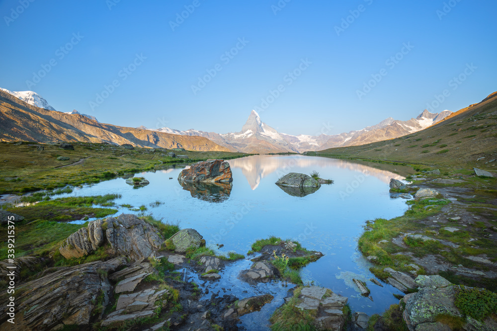Sunrise view on iconic mountain Matterhorn and Stellisee lake in Valais region, Switzerland, Europe