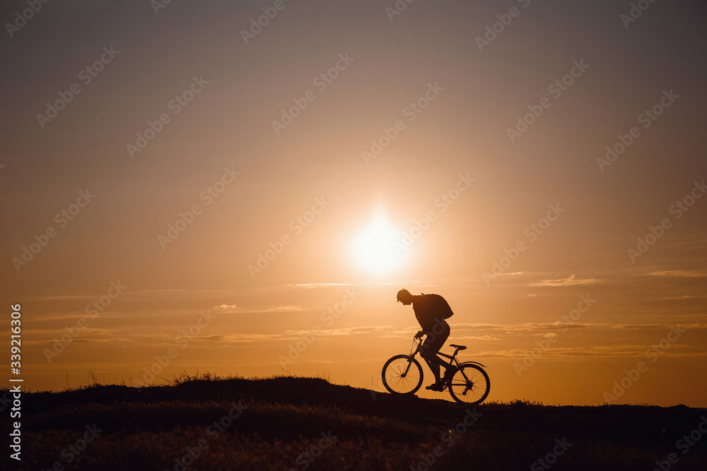 Silhouette of cyclist in motion at beautiful sunset. Silhouette of cyclist in motion at beautiful sunset.