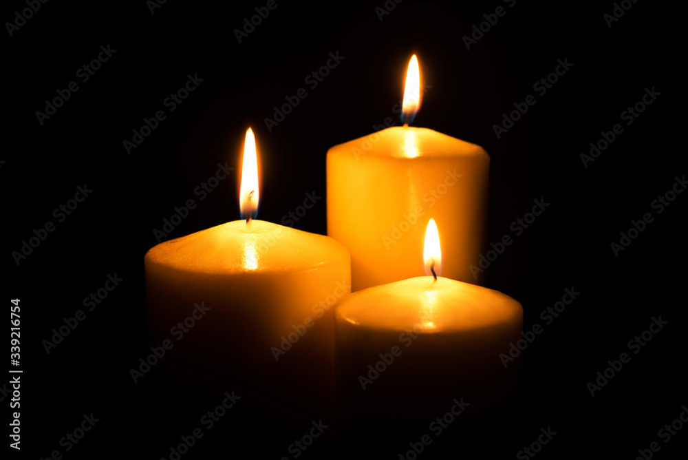 Flame candles isolated on black background. Close up. Flame candles isolated on black background. Close up.