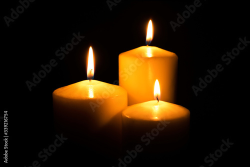 Canvas Print Flame candles isolated on black background. Close up.